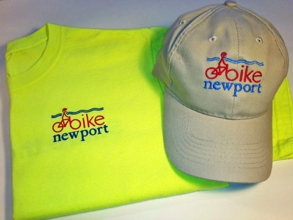 Photograph of t-shirt and hat with Bike Newport logo.